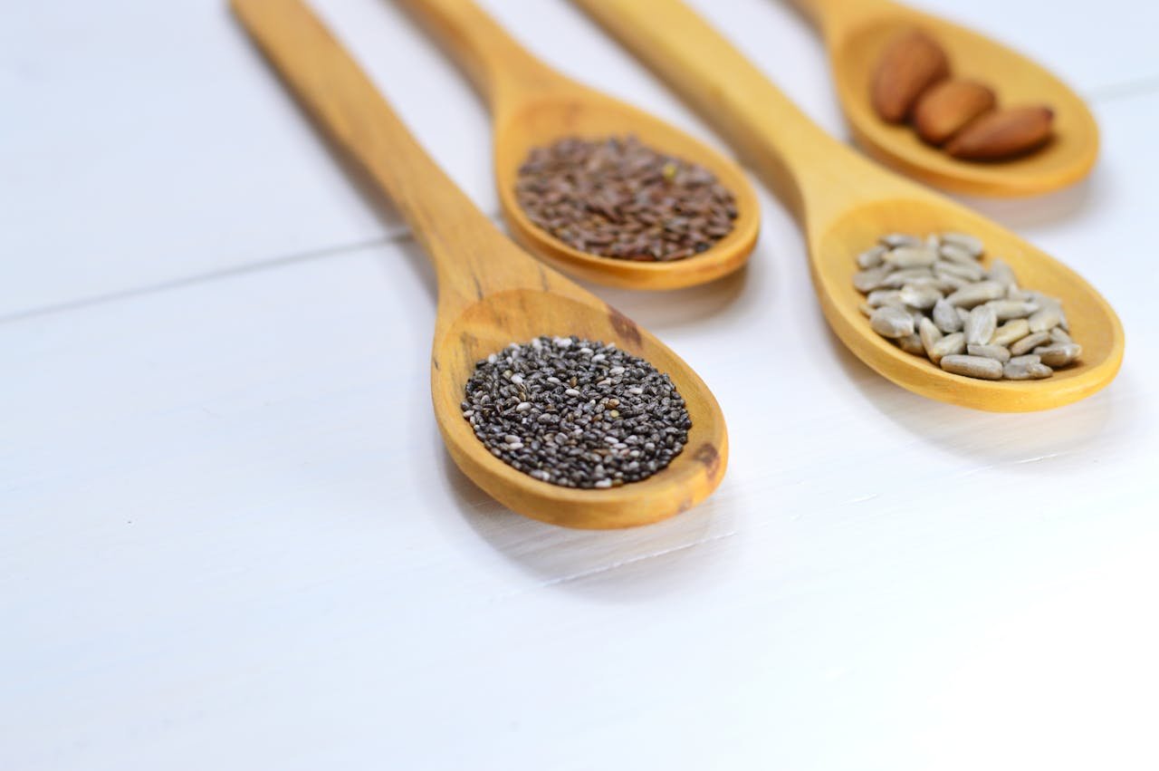 Closeup Photo of Four Brown Wooden Spatulas With Seds