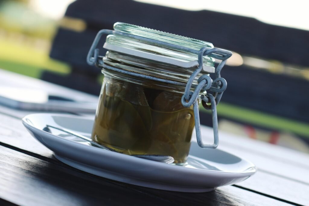 Clear Glass Air Tight Mason Jar Filled With Green Liquid