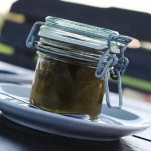 Clear Glass Air Tight Mason Jar Filled With Green Liquid